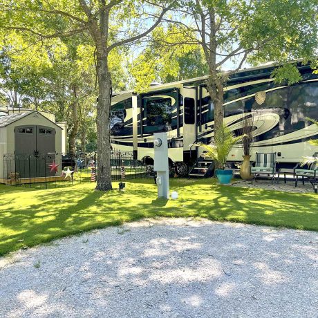 parked rv in grassy area with trees