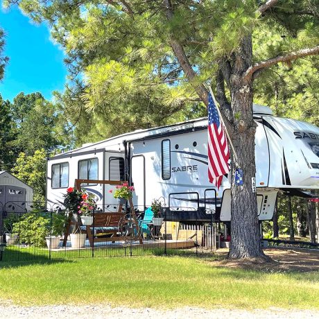 rv parked with trees and fenced area